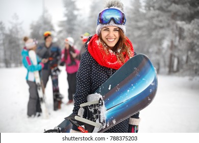 Female Snowboarder Hold Snowboard And Going To Snowboarding