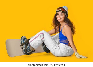 Female Snowboarder On Color Background