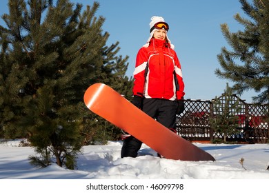 female snowboarder over blue sky in forest - Powered by Shutterstock