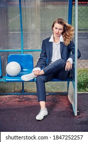 Female Soccer Coach Sits On The Podium In The Coaching Cabin