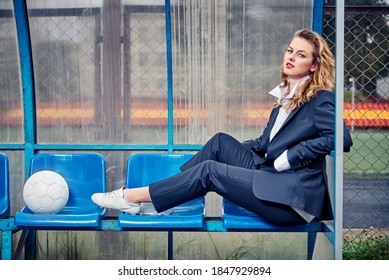 Female Soccer Coach Sits On The Podium In The Coaching Cabin