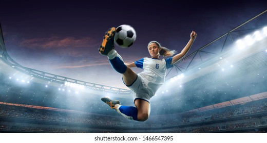 Female Soccer player in action on a professional soccer stadium. Girl playing soccer