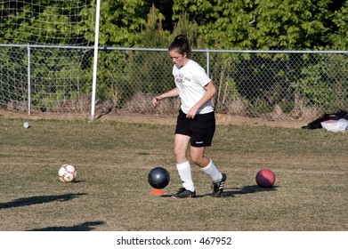 Female Soccer Player Dribbles