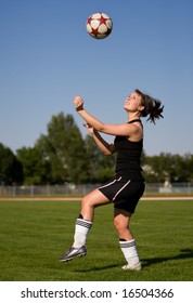 A Female Soccer Player Getting Ready To Head The Ball