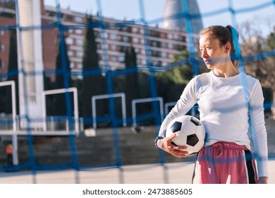 female soccer player holding a soccer ball - Powered by Shutterstock