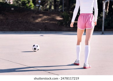 female soccer player preparing to kick soccer ball - Powered by Shutterstock