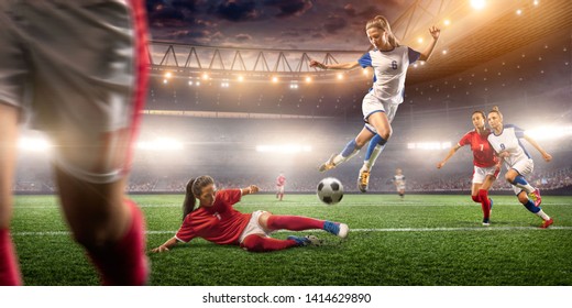 Female Soccer players performs an action play on a professional soccer stadium. Girls playing soccer