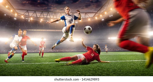 Female Soccer players performs an action play on a professional soccer stadium. Girls playing soccer - Shutterstock ID 1414629893