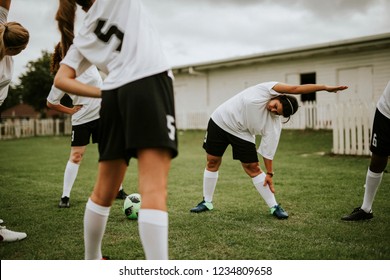 Female soccer team players stretching pre game - Powered by Shutterstock