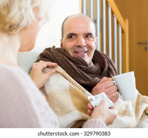 Female Social Worker Taking Care Of Senior Male Patient 
