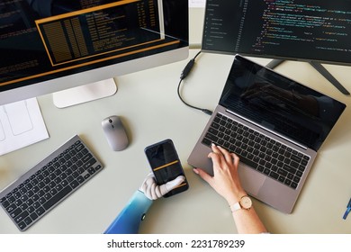 Female software developer with one prosthetic arm working on new mobile application