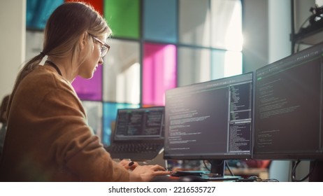 Female Software Engineer Writing Lines of Code on Professional Multiple Display PC Setup In Stylish Office. Caucasian Woman Fixing Bugs and Creating New Features For Innovative Digital Service. - Shutterstock ID 2216535727