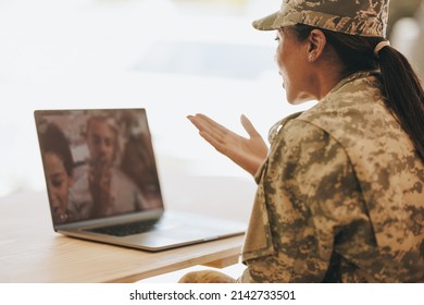 Female Soldier Blowing A Kiss While Video Calling Her Husband And Children From The Military Base. American Military Family Communicating Online.