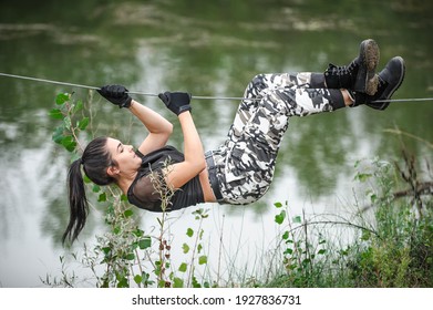 Female soldier conducts the rope bridge water crossing exercise. Water survival training - Powered by Shutterstock