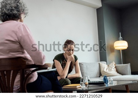 Female soldier having therapy meeting with senior psychologist.