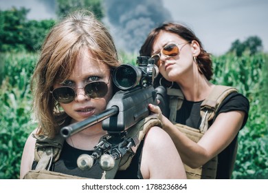 Female soldier shooting with sniper rifle. Woman with weapon. Firearm army shooting and tactical training. Outdoor shooting range