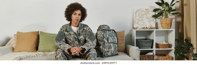 A female soldier sits thoughtfully in her living room, ready to embark on her military journey. - Powered by Shutterstock