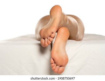 Female Soles On A White Bed And White Background