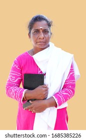 Female South Asian Doctor Holding A White Coat And Digital Tablet.