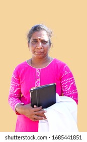 Female South Asian Doctor Holding A White Coat And Digital Tablet.