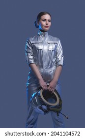 Female Space Explorer In Spacesuit Holding Helmet