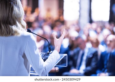 Female speaker at business conference, corporate presentation, workshop, coaching training, news conference, company meeting, public or political event. Public speaking concept. - Powered by Shutterstock