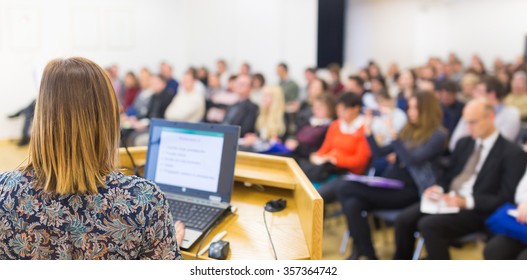 Female Speaker At Business Conference And Presentation. Audience At The Conference Hall. Business And Entrepreneurship. Business Woman. Horizontal Composition.