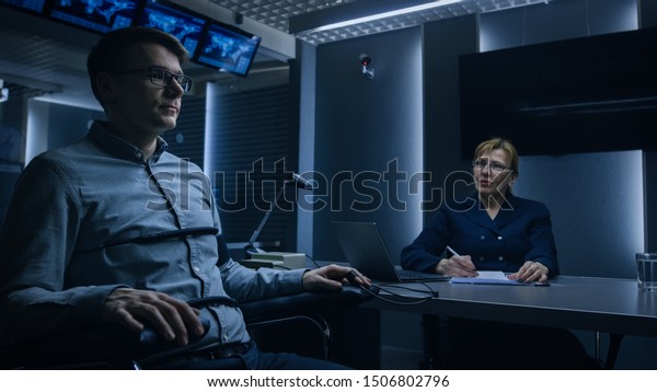 Female Special\
Agent Conducts Lie Detector / Polygraph Test on a Young Suspect.\
Expert Examiner Questions Accused in Interrogation Room. Computer\
Measures Physiological\
indices.