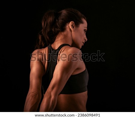 Similar – One young middle age athletic woman at crossfit training, exercising with trx suspension fitness straps over dark background, front view, looking up