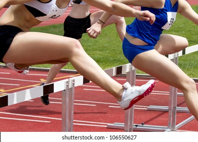 Female sprinter leaping over hurdles - Powered by Shutterstock