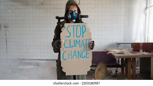 Female Stalker In Gas Mask With Banner Says Stop Climate Change. Disaster Concept