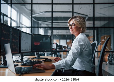 Female Stockbroker In Formal Clothes Works In The Office With Financial Market.