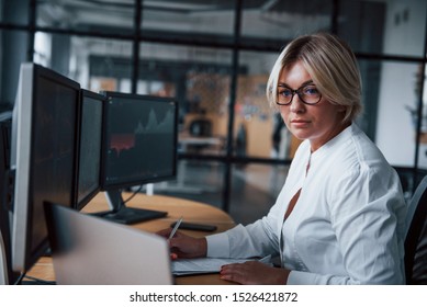 Female Stockbroker In Formal Clothes Works In The Office With Financial Market.