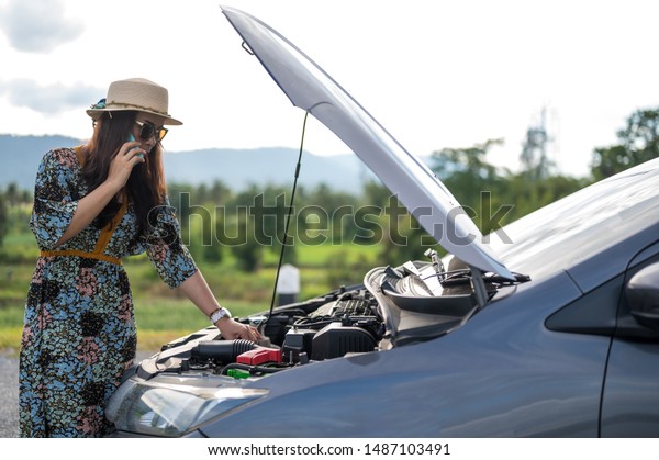 female In\
The Street With Broken Car Calling For\
Help