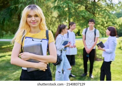 Female Student 16, 17 Years Old With Textbooks Backpack, In School Park