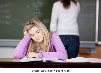 Female student is bored and almost falling asleep during class - Powered by Shutterstock