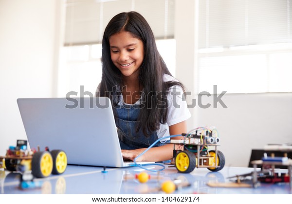 Female Student Building And\
Programing Robot Vehicle In After School Computer Coding\
Class