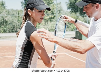 Female Student With Coach At Tennis Class