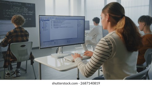 Female Student Performs Practical Coding Task. At University, During Game Dev Lecture, Young Woman Writes Program Code. Concept Modern Education, Studying Computer Science, Future Technology Skills.