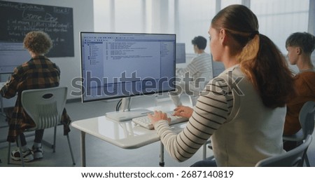 Female Student Performs Practical Coding Task. At University, During Game Dev Lecture, Young Woman Writes Program Code. Concept Modern Education, Studying Computer Science, Future Technology Skills.