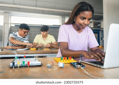 Female Student programming electronics circuit board in the engineering course - Technology girl at school - Powered by Shutterstock