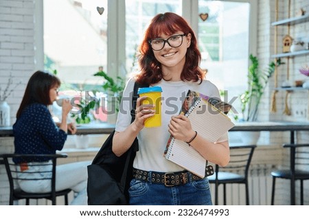 Female student with takeaway coffee in college coffee shop