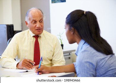 Female Student Talking To High School Counselor