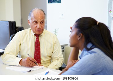 Female Student Talking To High School Counselor