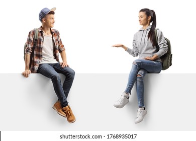 Female Student Talking To A Male Firend And Sitting On A Panel Isolated On White Background