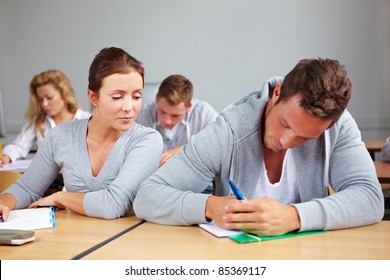 Female Student Trying To Cheat At Test In Class