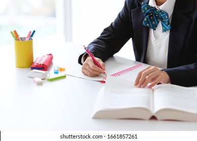 A female student wearing a uniform to study