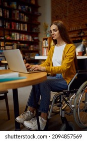 Female Student In Wheelchair Using Laptop