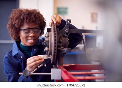 Female Student Working On Car Brakes On Auto Mechanic Apprenticeship Course At College - Shutterstock ID 1704725572