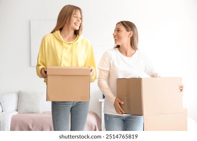 Female students with boxes in dorm room on moving day - Powered by Shutterstock